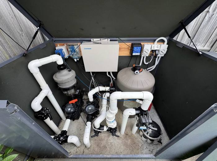 In-floor pool system equipment pad with pumps, sand filter, and Hayward automation